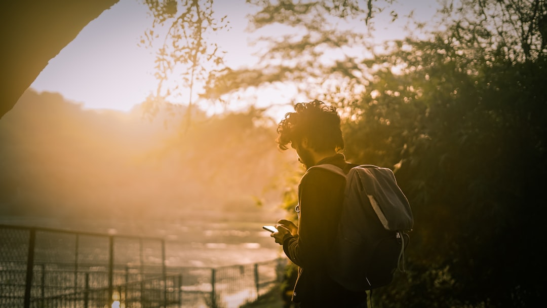 silhouette of man and woman kissing during sunset