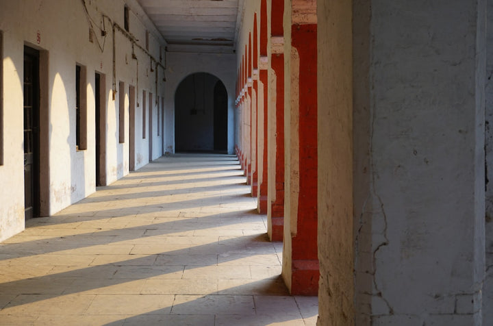 a long hallway with red and white columns
