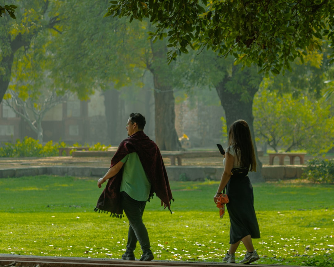 a man and a woman walking in a park