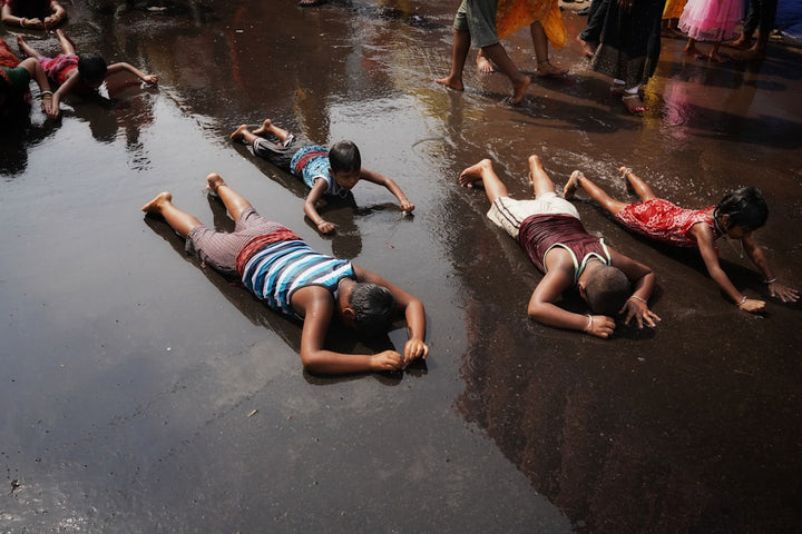 a group of people laying on the ground in the rain
