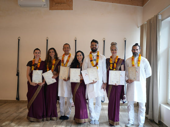 Group of people in traditional indian attire holding certificates